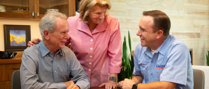 three people discussing at a kitchen table